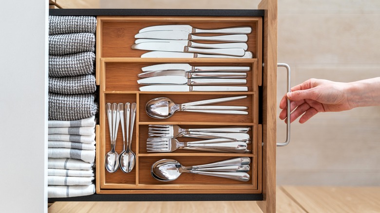 silver utensils arranged in drawer