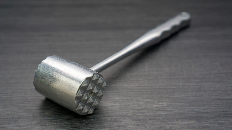 metal meat tenderizer on counter