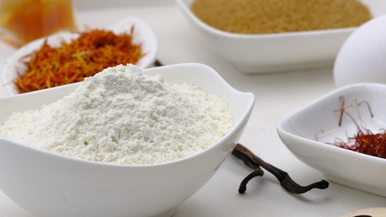 White bowls of flour and spices