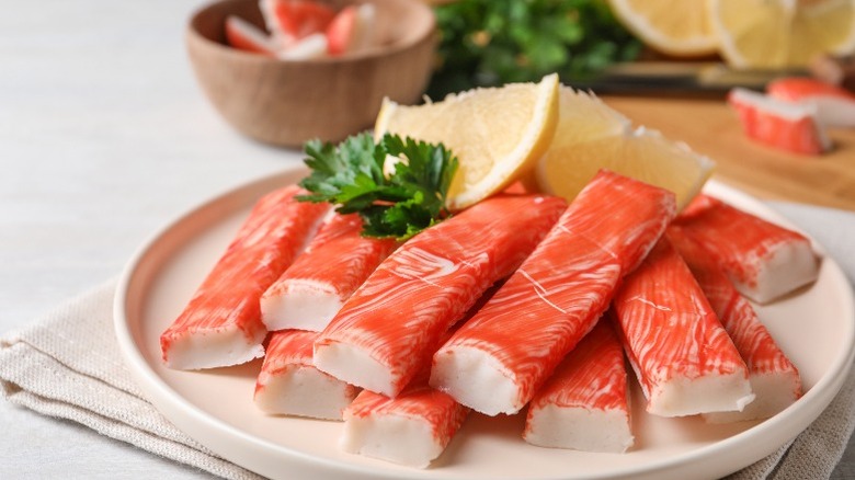 Crab sticks on plate with lemon