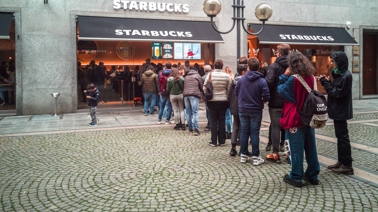 Starbucks store with a long line of people spilling out of it