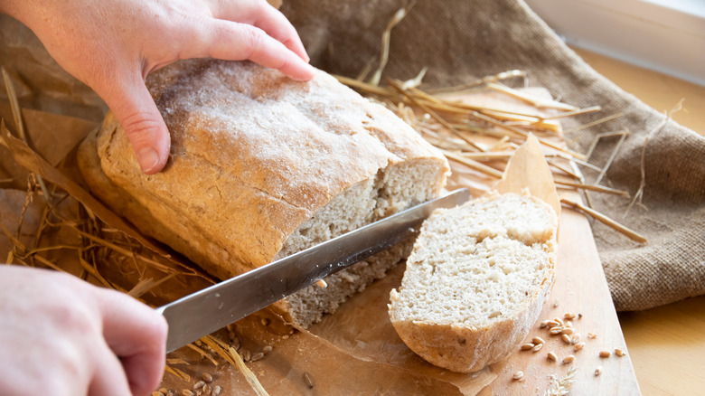 Fresh bread being sliced