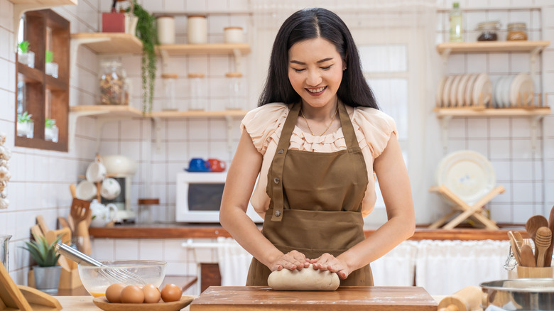 woman kneading bread