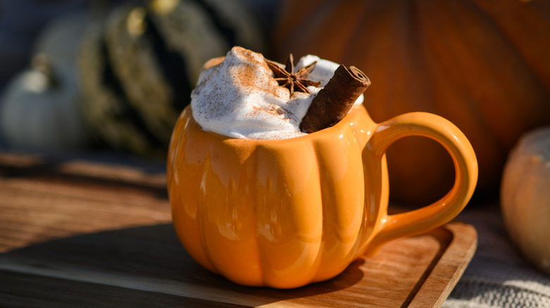 A pumpkin spice latte in a pumpkin mug