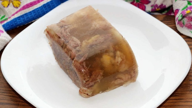 Square white plate with slice of jellied moose nose
