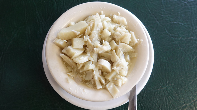White bowl filled with swamp cabbage stew