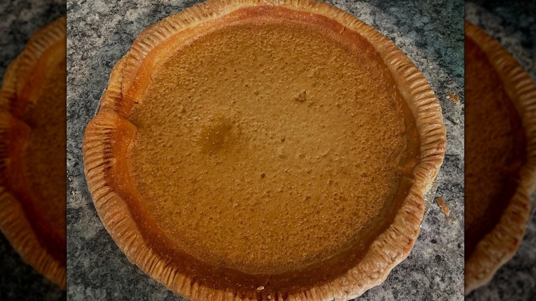 Whole vinegar pie on granite background