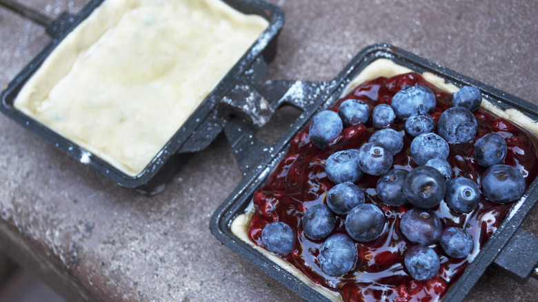 pie iron filled with blueberries and jelly