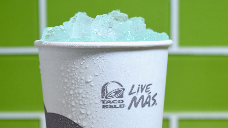 Frozen teal drink in cup reading "Live Más" with Taco Bell logo