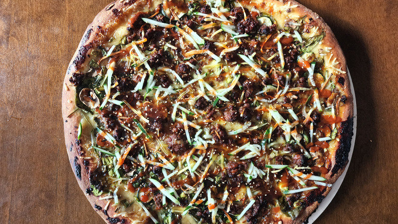 Frozen Bulgogi pizza on wooden table