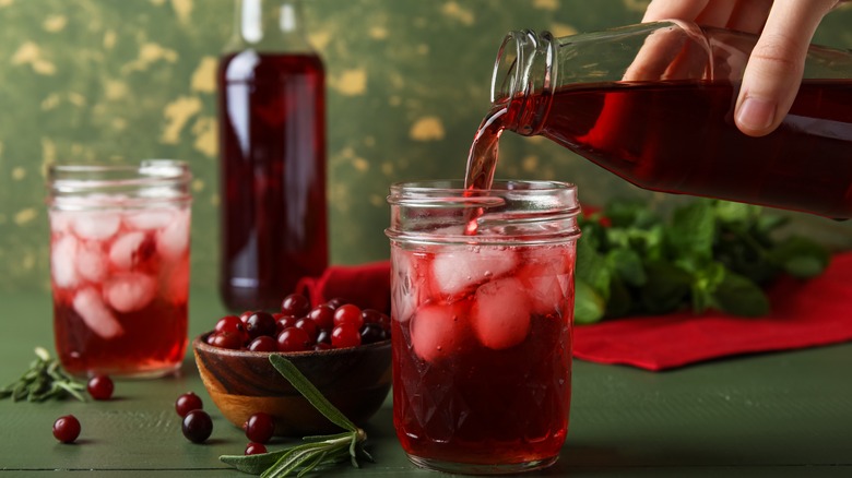 Cranberry juice pouring into glass
