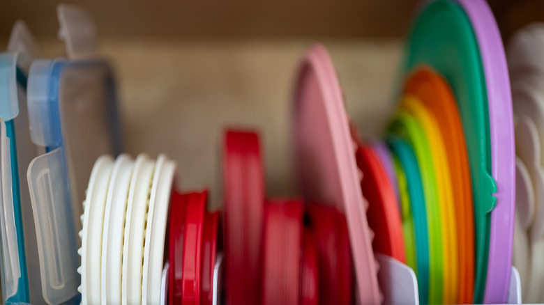 Close-up of container lids neatly organized in a cabinet
