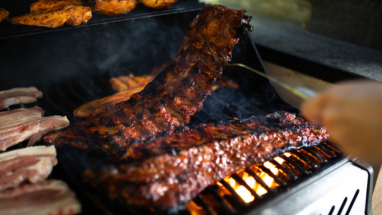Juicy, glazed meat sizzling on a hot grill