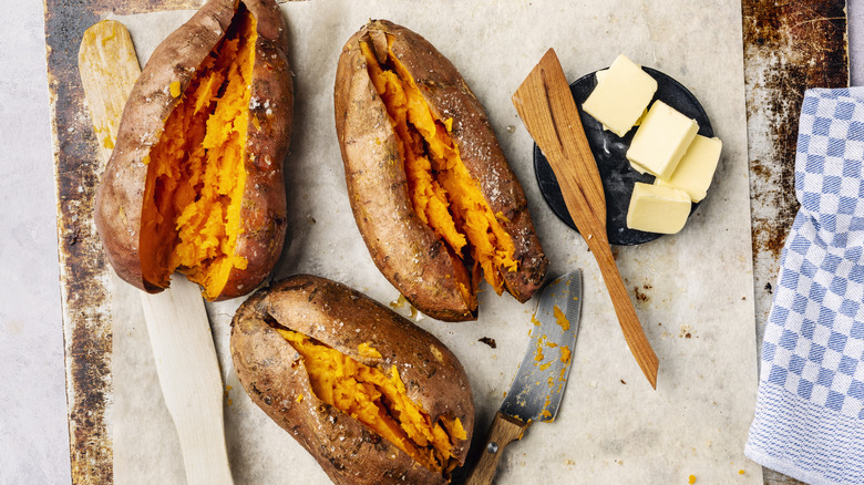 Three roasted sweet potatoes with butter