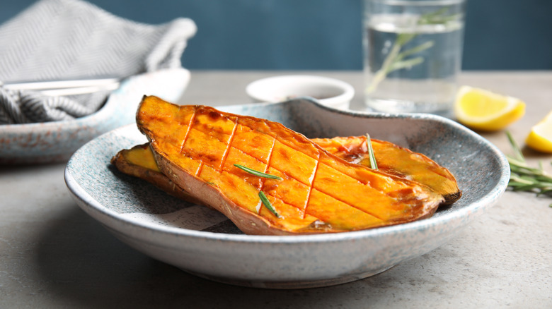 Halved and baked sweet potato in bowl
