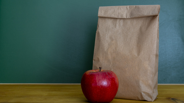 Brown paper bag lunch with apple