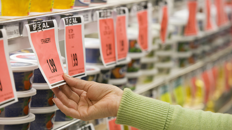 Refrigerated grocery display case with drinks and hot dogs