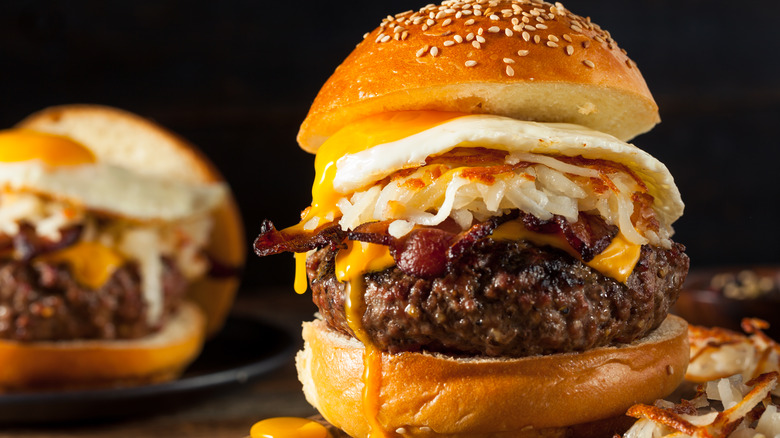 A breakfast burger against a black background