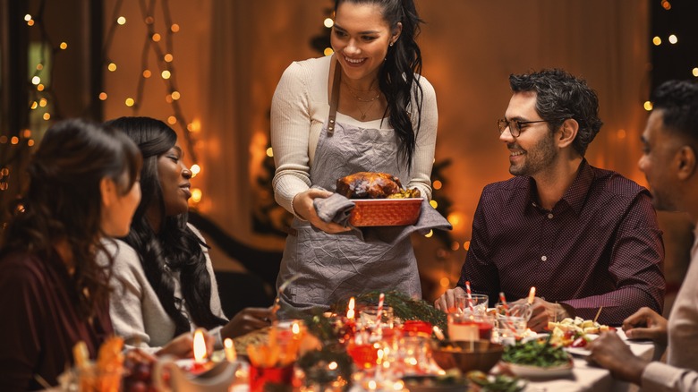 Hostess serving friends holiday meal
