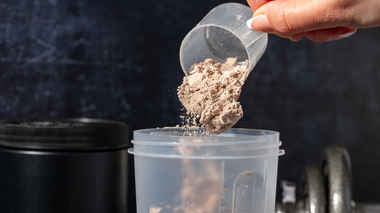 Pouring protein powder into cup