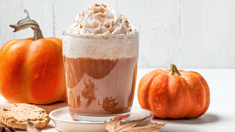 pumpkin spice latte next to mini pumpkins