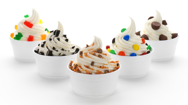 Frozen yogurt cups with various toppings