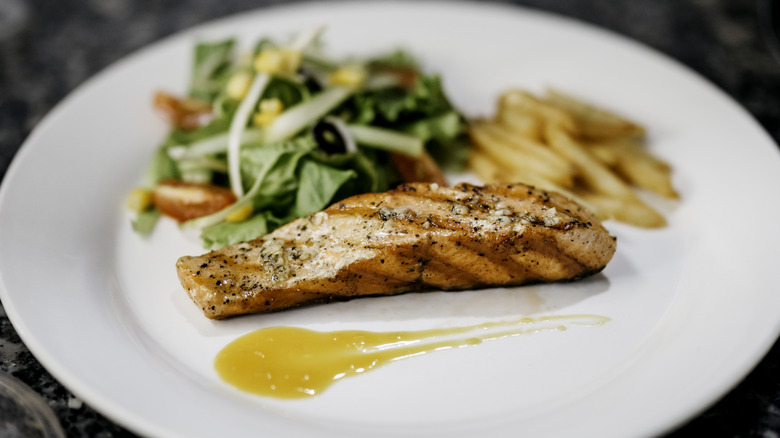 Grilled salmon steak with green asparagus.