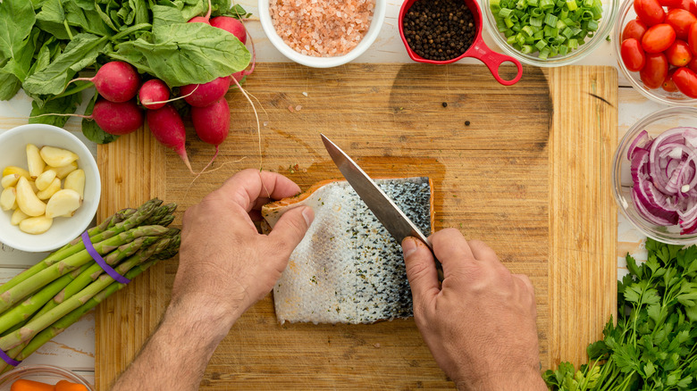 Man preparing a fresh salmon