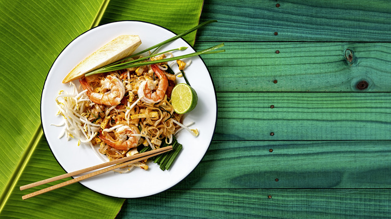 prawn pad thai on green background