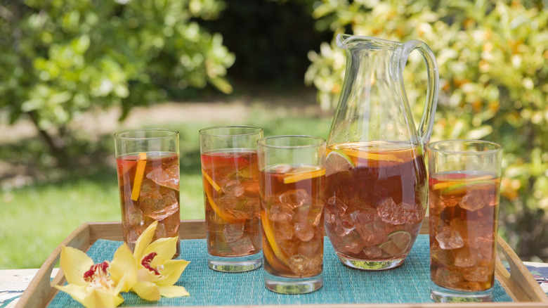 Pitcher and glasses full of sweet tea on tray