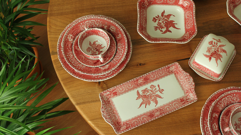 Red and white patterned dishware on a wood table