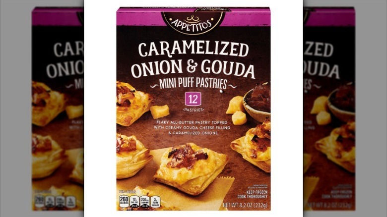 Box of onion and gouda puff pastries on white background