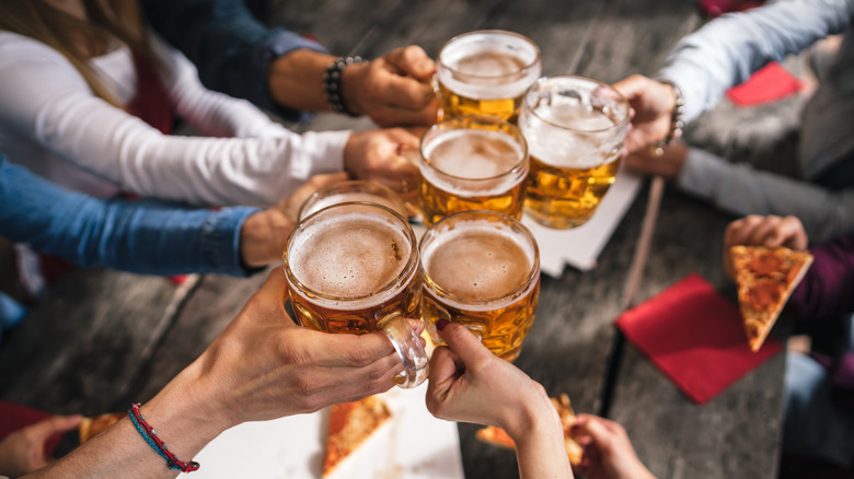 group enjoying beer and pizza