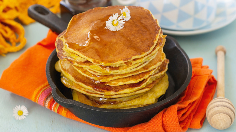 A stack of hoe cakes in a cast iron skillet
