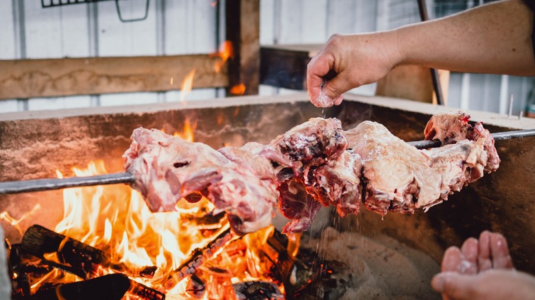 A chef preparing grilled mutton on the barbecue