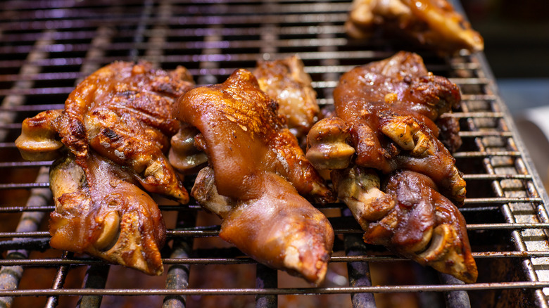 Pig's feet barbecuing on the grill