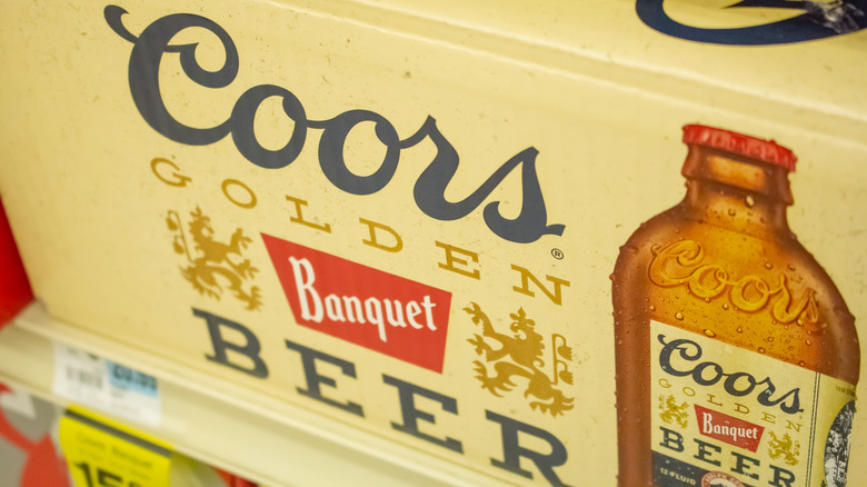 Case of Coors Banquet beer bottles with close-up of logo