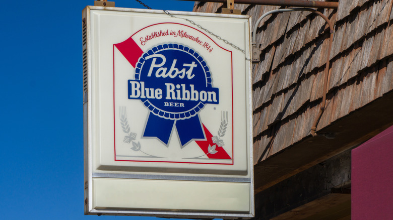 Pabst Blue Ribbon beer sign hanging from roof of a shop in Minnesota