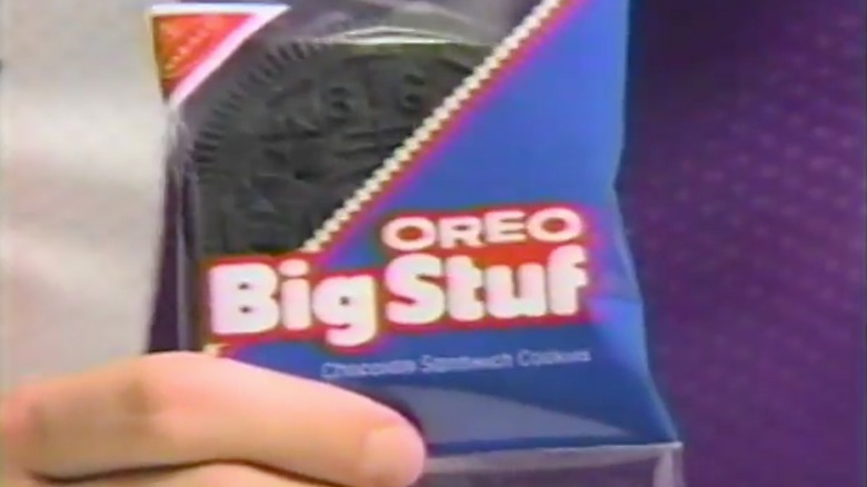 Hand holding individually wrapped Oreo Big Stuf