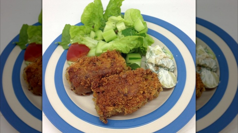 Crubeens, a pair of breaded and fried pig trotters, served with salad