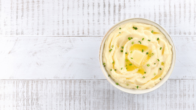 A bowl of champ, with melted butter and green onions