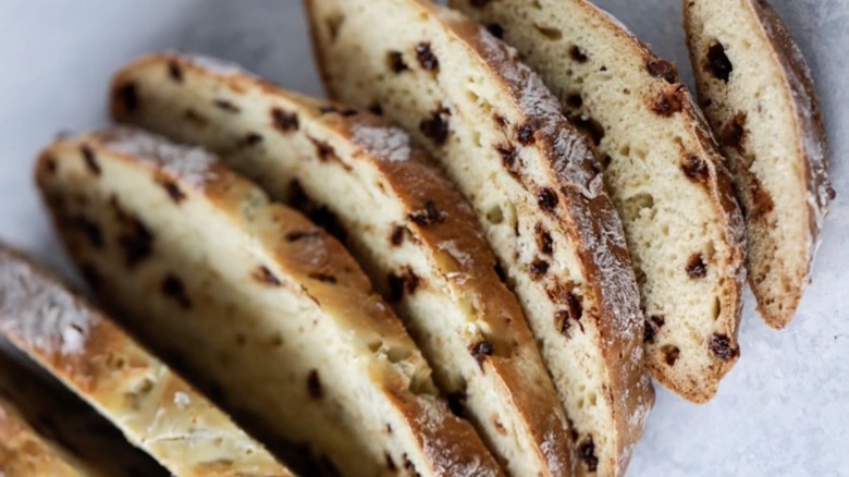 Slices of spotted dog showing raisins in its bready interior