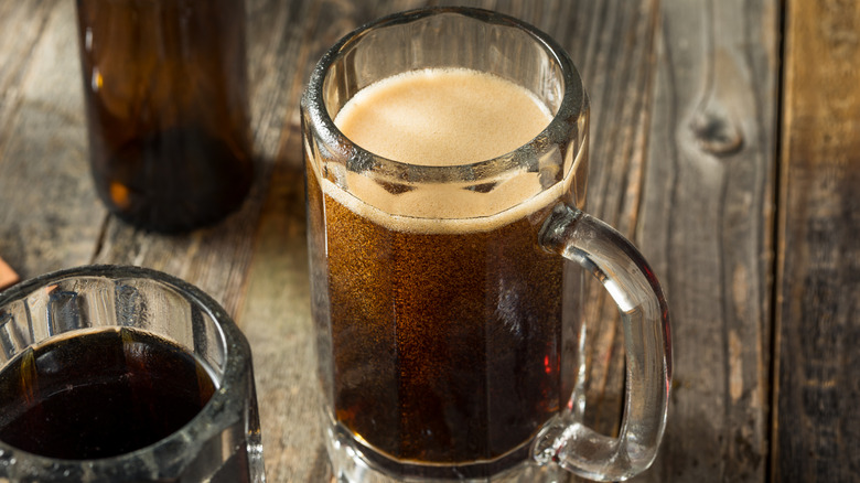 Overhead view of a mug of birch beer on a wooden tabletop