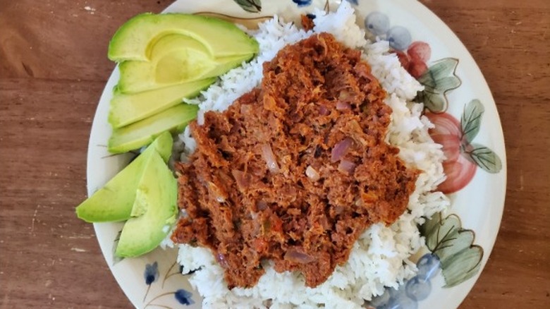 A plate of traditional bully beef and rice served with pears
