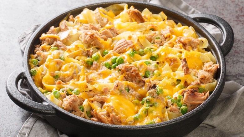 A black dish of baked tuna noodle casserole