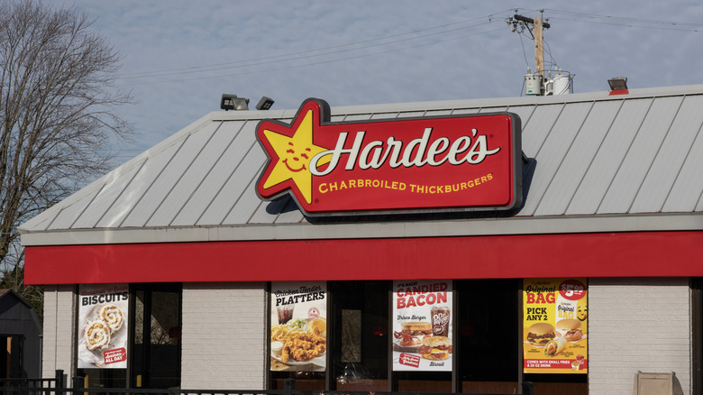 Hardee's restaurant with signage and offers advertised in the windows