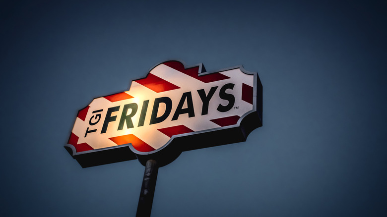 TGI Fridays sign illuminated against the evening sky