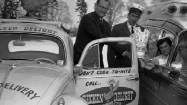 A Chicken Delight employee delivering fast food