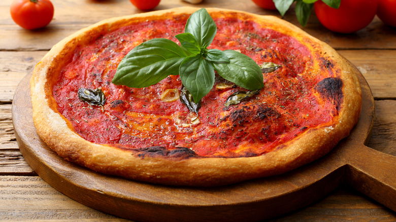 Neapolitan pizza with basil sprig