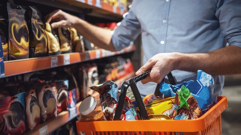 Shopper reaching for a product in grocery store